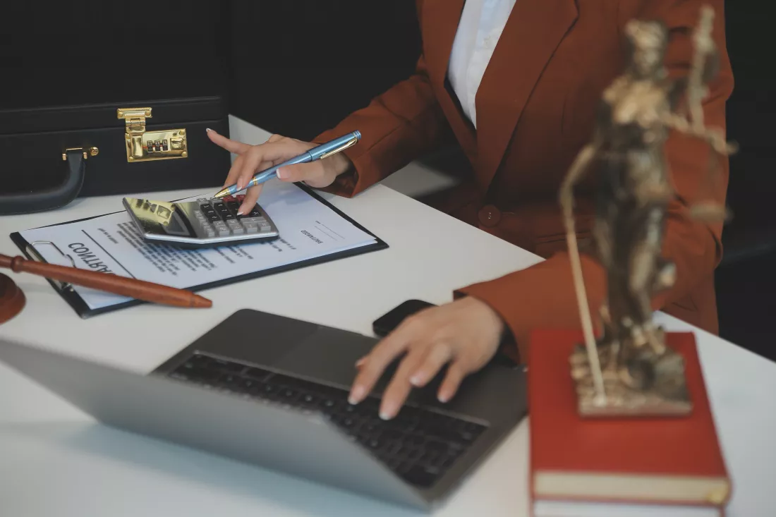 american-woman-lawyer-businesswoman-african-working-with-laptop-searching-analyzing-data-reading-contract-documents-work-with-law-books-hammer-justice-consulting-lawyer-concept