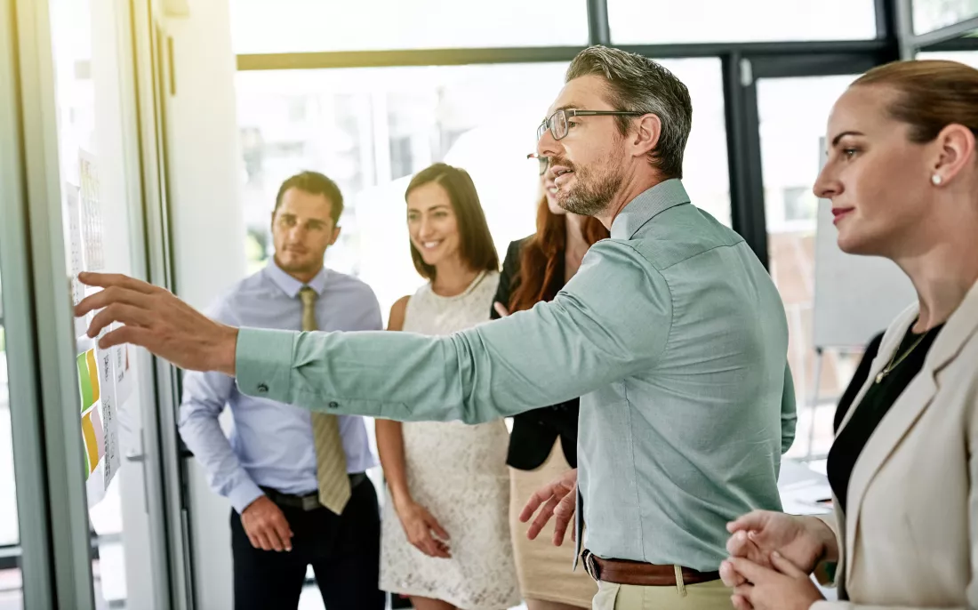 business-people-glass-wall-mentor-meeting-brainstorming-ideas-schedule-teamwork-group-staff-colleagues-office-discussion-solution-planning-project-creative-agency