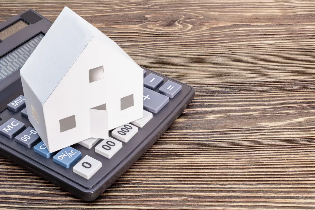 concept-mortgage-sale-rental-housing-real-estate-mortgage-credit-lending-calculator-which-there-is-mock-up-paper-house-wooden-background-copy-space