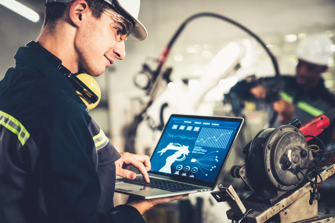 young-factory-worker-working-with-adept-robotic-arm